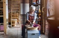 Elderly woman making ceramic work with potter`s wheel Royalty Free Stock Photo