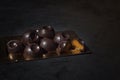 Hand-made chocolates, each candy is different and unique. Dark chocolate on velvet and gold.