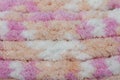 Hand made crochet pattern of a colorful sheep wool yarn.