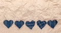 Hand made Jeans hearts on a crumpled craft paper background. Flat lay, top view, minimal style, copy space for text. Symbol of lov Royalty Free Stock Photo