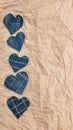 Hand made Jeans hearts on a crumpled craft paper background. Flat lay, top view, minimal style, copy space for text. Symbol of lov Royalty Free Stock Photo