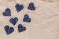Hand made Jeans hearts on a crumpled craft paper background. Flat lay, top view, minimal style, copy space for text. Symbol of Royalty Free Stock Photo