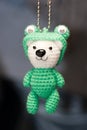 Hand made key ring brown teddy bear knitted doll wearing a green shirt