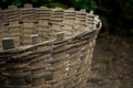 Hand made multipurpose basket made of bamboo on the ground on a mossy stone pile background