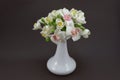 Hand made polymer clay flower bouquet in a white vase on a dark