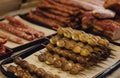 Hand made smoked meat products. Display meats, cold cuts and sausages at the street food fair. Soft focus blurred and noise effect