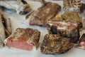 Hand made smoked meat products. Display meats, cold cuts and sausages at the street food fair. Soft focus blurred and noise effect