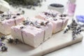 Hand made soap bars with lavender flowers on cutting board Royalty Free Stock Photo