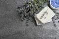 Hand made soap bars with lavender flowers on stone table, flat lay. Space for text Royalty Free Stock Photo