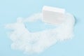 Hand made soap in lush white foam on a light blue background. cosmetic background banner