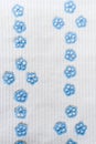 Hand-made textile white background with two rows cutted and sewn blue flowers. Royalty Free Stock Photo