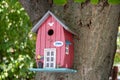 Hand made wooden shelter, bird house, placed on the tree in forest Royalty Free Stock Photo