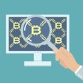 Hand with magnifier analyzing bitcoin