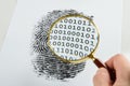 Hand with magnifying glass over a finger print Royalty Free Stock Photo
