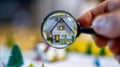 Hand with magnifying glass over house. Choice of real estate to buy and invest in. Home searching concept Mortgage loan Royalty Free Stock Photo