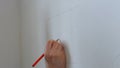 Hand make wall marking with pencil. Royalty Free Stock Photo