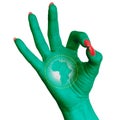 A hand makes a good sign, the flag of the African Union, painted as a symbol of better quality, positivity and success