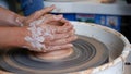 Hand making clay pottery at throwing wheel. Royalty Free Stock Photo