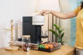 hand making Espresso Coffee by Coffee Maker Machine with Capsule of roasted coffee bean on wood table bar. Daily beverage drink at Royalty Free Stock Photo