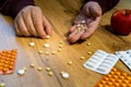 hand making happy face out of pills on the table drugs addiction concept