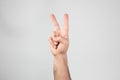 Hand making the victory sign Royalty Free Stock Photo