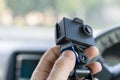 The hand of a male car driver that holds a car DVR Royalty Free Stock Photo