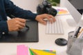 Hand of male designer working at his desk using stylus and digital graphics tablet Royalty Free Stock Photo