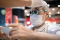 Hand of a male doctor changing lenses in eye testing glasses or trial frame to diagnose senior woman vision,old people eyesight is Royalty Free Stock Photo