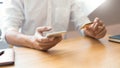 Hand of man in casual shirt paying with credit card and using smart phone for online shopping making orders via the Internet using Royalty Free Stock Photo