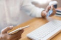 Hand of man in casual shirt paying with credit card and using smart phone for online shopping making orders via the Internet using Royalty Free Stock Photo