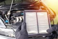 Hand a man change and check air filter of car in the engine room Royalty Free Stock Photo