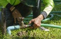 Hand of a man connecting a pipe with a tap in garden Royalty Free Stock Photo