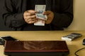 Hand Of Man Is Counting His Money at His Desk. Royalty Free Stock Photo