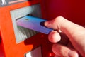 Hand of a man with a credit card, using an ATM. Royalty Free Stock Photo