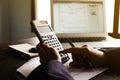 Close up of Hand man doing finances and calculate on desk about cost at home office.Savings, finances and economy concept. Royalty Free Stock Photo