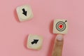 Hand of man finger pointing selection wooden cube blocks with Goal icon.