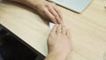 Hand of a man folding a sheet of paper to make a plane. Stock footage. Concept of creative activities, close up of male Royalty Free Stock Photo