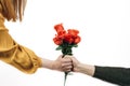 Hand of a man giving a bouquet of red flowers to a woman Royalty Free Stock Photo