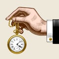 Hand of man with a gold retro pocket watch