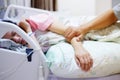 Hand of man hold hands with woman on the hospital bed Royalty Free Stock Photo