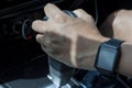 Hand of man holding automatic transmission lever.