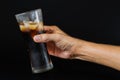 Hand of a man holding a cola glass with ices Royalty Free Stock Photo