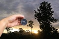 hand of a man holding a compass in evening sunset at countryside Royalty Free Stock Photo