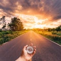 Hand man holding compass on road Royalty Free Stock Photo