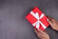 Hand of man holding gift giving on cement floor in Christmas day or holiday. Royalty Free Stock Photo