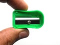 Hand holding green pencil sharpener