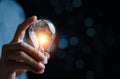 Hand man holding illuminated lightbulb, idea, changing innovation and inspiration with worldclass, smart intelligent creativity