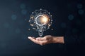 Hand man holding illuminated lightbulb, idea, innovation and inspiration with glowing virtual brain, smart intelligent creativity Royalty Free Stock Photo