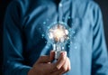 Hand man holding illuminated lightbulb, idea, innovation and inspiration with glowing virtual brain, smart intelligent creativity Royalty Free Stock Photo