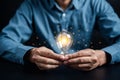 Hand man holding illuminated lightbulb, idea, innovation and inspiration with glowing virtual brain, smart intelligent creativity Royalty Free Stock Photo